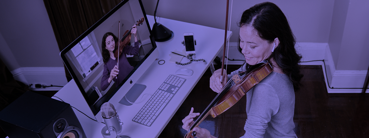 Teacher and Student playing their violins over Zoom
